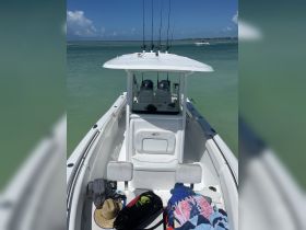 A view of the interior of a fishing boat, showcasing the helm and seating area, perfect for a day out on the water.
