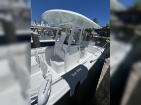 A well-equipped boat interior featuring comfortable seating and a helm area, perfect for fishing or leisure outings on the water.