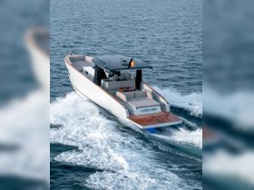 A sleek speedboat named 'Andiamo' glides through the water, showcasing its elegant design and performance on the open sea.