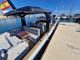 A stylish interior view of a modern boat featuring comfortable seating and a sleek console, perfect for relaxing on the water.