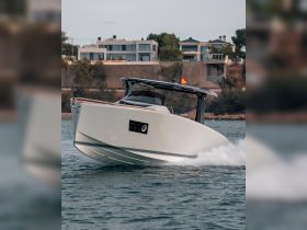 A sleek speedboat glides through the water, showcasing its modern design and performance. Perfect for thrilling day trips on the water.