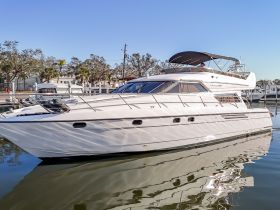 A sleek yacht docked peacefully, showcasing its elegant design and reflections in the calm water — perfect for luxury cruising or private charters.