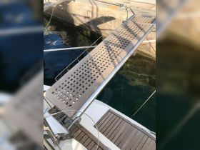 A detailed view of a boat's boarding platform, showcasing the sleek design and functionality, ideal for easy access to and from the water.