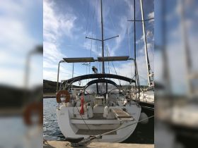 A sleek yacht named 'Azul' docked at the marina, showcasing its elegant design against a backdrop of blue skies.