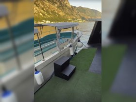 Interior view of a boat showcasing comfortable seating and a clean, modern design, perfect for relaxing on the water.