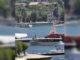 A lively scene at the harbor with a boat full of passengers, showcasing the vibrant atmosphere of on-water activities and exploration.