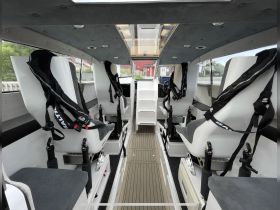 Interior view of a modern boat cabin featuring comfortable seating and a well-equipped helm, ideal for a smooth and enjoyable boating experience.