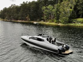 A sleek speedboat navigates through calm waters, surrounded by lush greenery — perfect for exploring scenic waterways.