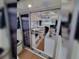 A well-designed interior of a boat featuring comfortable seating and a helm area, perfect for relaxing and navigating on the water.