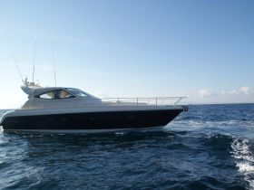 A sleek yacht glides through the open water, showcasing its elegant design and smooth lines — perfect for luxury cruising adventures.