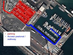 Aerial view of a marina layout showing parking and walkway access, but the details are unclear.
