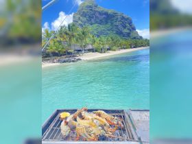 Freshly grilled lobster on a barbecue, set against a stunning tropical backdrop — perfect for a luxurious dining experience on the water.