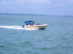 A sleek speedboat glides through the turquoise waters, showcasing its vibrant design and perfect for thrilling adventures on the open sea.