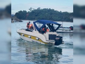 A group of passengers wearing life jackets enjoy a boat ride, showcasing the excitement of on-water adventures.