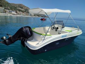 A sleek motorboat with a Mercury engine, docked in calm waters, showcasing its stylish design and the beautiful coastal scenery of Sicily.