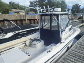 A clear view of a boat named 'Deep Drop' docked at the marina, showcasing its sleek design and features.