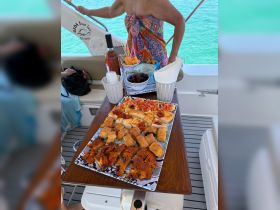 A beautifully arranged platter of snacks and drinks on a boat, perfect for enjoying a relaxing day on the water with friends or family.