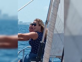 Two women enjoy a joyful moment while sailing, capturing the essence of fun and adventure on the water.