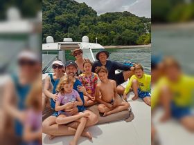 A joyful family poses together on a boat, enjoying their time on the water — perfect for family outings and adventures.