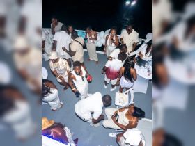 A vibrant party scene aboard a boat, featuring a lively group dressed in white enjoying drinks and celebrating together — perfect for unforgettable nights on the water.