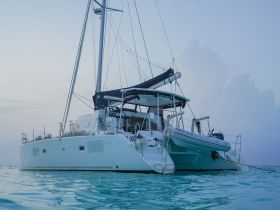 A stunning catamaran anchored in tranquil waters, showcasing its sleek design and perfect for leisurely sailing adventures.