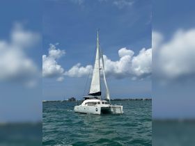 A stunning catamaran sails gracefully through the turquoise waters under a bright blue sky, perfect for exploring coastal destinations.