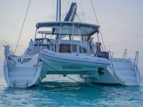 A stunning catamaran anchored in calm waters, showcasing its sleek design and inviting atmosphere for future adventures.