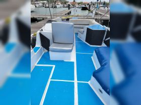 Interior view of a boat showcasing comfortable seating and a well-maintained cabin area, perfect for relaxing during a day on the water.