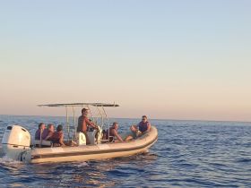 A lively group enjoys a boat ride on the open water, showcasing the fun and adventure of on-water activities.
