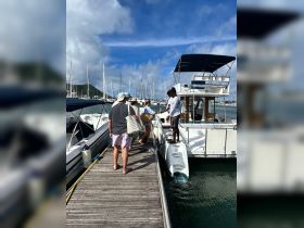 A group of guests boards a boat at the marina, ready for an exciting day on the water. The vibrant atmosphere captures the anticipation of a memorable boating experience.