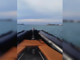 Interior view of a sleek inflatable boat showcasing comfortable seating and a well-equipped helm, perfect for exploring coastal waters.