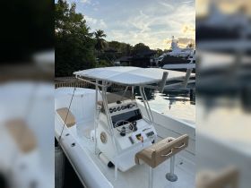 A clean and spacious helm area of a boat, featuring a well-equipped console and comfortable seating, perfect for navigating the waters.