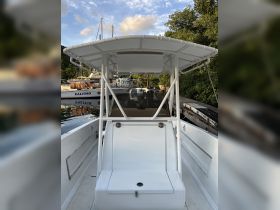 Interior view of a boat's helm area, showcasing the seating and console, perfect for navigating the waters.