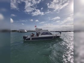 A lively scene on the water featuring a group of people aboard a boat, showcasing the fun and excitement of a day out on the water.