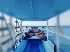 Interior view of a boat showcasing the seating area and cabin design, perfect for enjoying a day on the water.