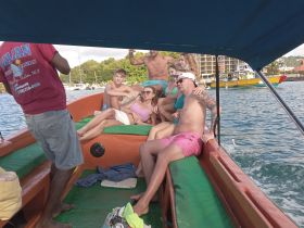 A lively group enjoys their time aboard a boat, capturing the essence of fun and adventure during their tour. Perfect for showcasing group outings on the water.