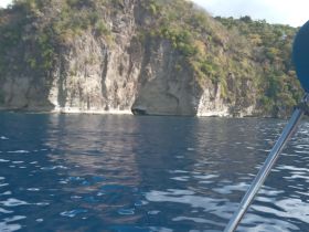 A stunning view of a rocky coastline reflected in the calm waters, perfect for showcasing the natural beauty of the area.