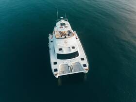 A stunning aerial view of a luxurious yacht cruising through calm waters, showcasing its elegant design and spacious layout.