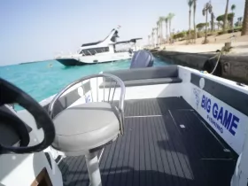 Interior view of a fishing boat featuring a comfortable helm seat, ideal for anglers looking to enjoy a day on the water.