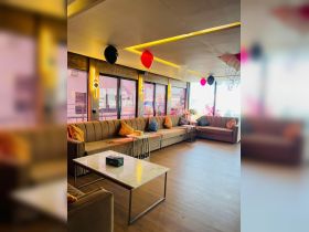 A stylish interior view of a boat's lounge area, featuring comfortable seating and festive decorations, perfect for gatherings and celebrations on the water.