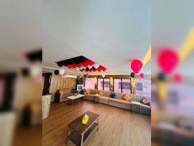 A beautifully decorated interior of a boat featuring comfortable seating and festive balloons, perfect for hosting events or gatherings on the water.