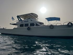A stunning side view of the 'Sea Master' yacht, showcasing its elegant design against a serene backdrop, perfect for luxury charters and coastal adventures.