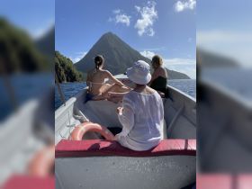 A group enjoys a scenic boat ride with stunning views of a mountain in the background, perfect for capturing memorable moments on the water.
