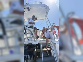 A joyful moment aboard a boat with a family enjoying their time together, showcasing the fun and relaxation of a day on the water.