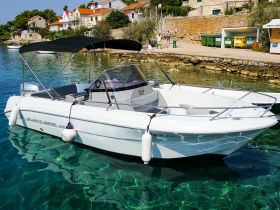 A sleek speedboat named 'Atlantic Marine' docked in crystal-clear waters, showcasing its elegant design and perfect for summer adventures.