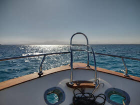 A stunning view from the front of a boat, showcasing sparkling waters and distant mountains — perfect for capturing the essence of a serene day on the sea.