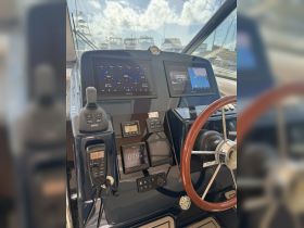 A detailed view of the helm and control console inside a boat, showcasing advanced navigation and monitoring systems — perfect for boating enthusiasts and captains.