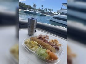 A delicious charcuterie platter featuring fresh fruits and snacks, perfect for enjoying on a boat trip. Ideal for catering or casual dining while cruising.
