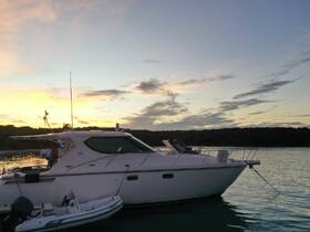 A couple enjoys a serene sunset aboard a boat, creating a perfect backdrop for relaxation and romantic moments on the water.