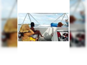 A group of friends relaxes inside a boat, enjoying drinks and the scenic view — perfect for a fun day on the water.